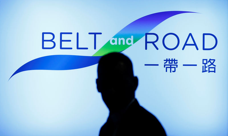 © Reuters. FILE PHOTO: A man walks past the podium at the Belt and Road summit in Hong Kong