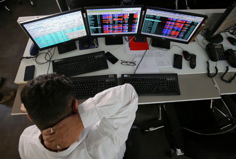 © Reuters. A broker reacts while trading at his computer terminal at a stock brokerage firm in Mumbai