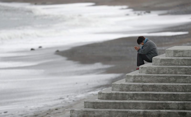 © Reuters. Campanas y sirenas conmemoran el aniversario del tsunami en Japón
