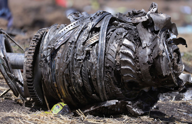 © Reuters. Airplane engine parts are seen at the scene of the Ethiopian Airlines Flight ET 302 plane crash, near the town of Bishoftu