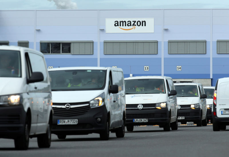 © Reuters. Delivery vehicles leave an Amazon logistics centre in Mannheim