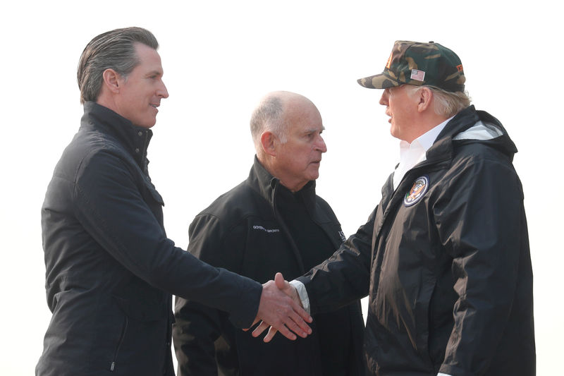 © Reuters. FILE PHOTO: President Donald Trump shakes hands with then-Governor-elect Gavin Newsom upon arriving at Beale Air Force Base California