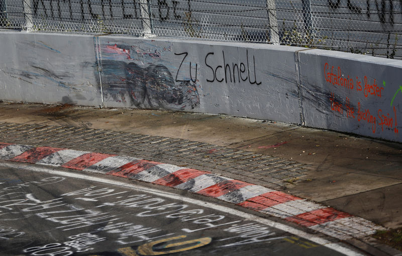 © Reuters. FILE PHOTO: A graffiti is seen at a damaged circuit boundary at the "Breitscheid" section of the Nuerburgring Nordschleife racing circuit