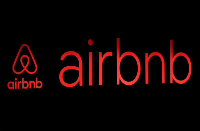 © Reuters. FILE PHOTO: The logos of Airbnb are displayed at an Airbnb event in Tokyo