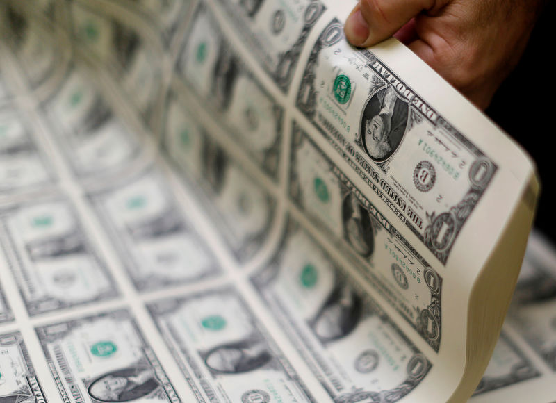 © Reuters. FILE PHOTO: United States one dollar bills are curled and inspected during production at the Bureau of Engraving and Printing in Washington