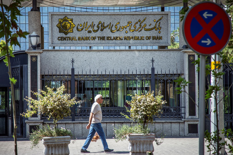 © Reuters. A man walks past the Central bank of Iran in Tehran