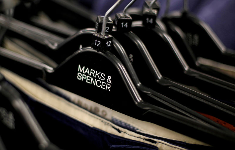 © Reuters. FILE PHOTO: File photo of clothes displayed on hangers in an Marks & Spencer shop in northwest London