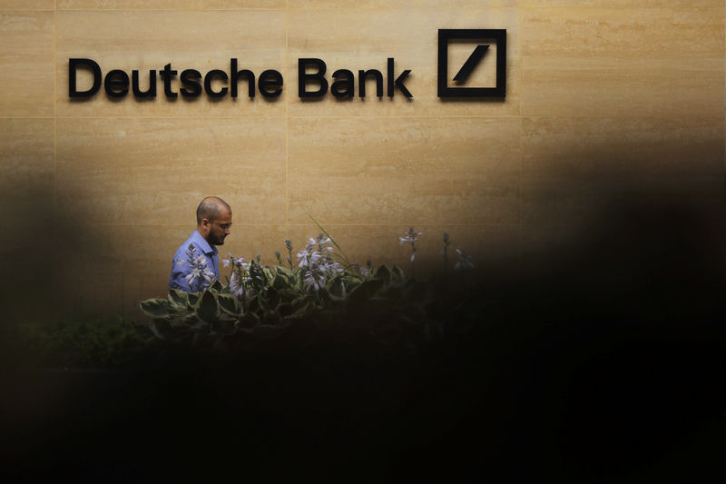 © Reuters. A man walks past a Deutsche Bank office in London