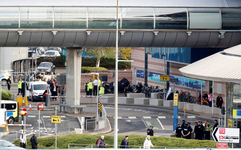 © Reuters. Police officers are seen as a suspect package was found at Manchester Airport