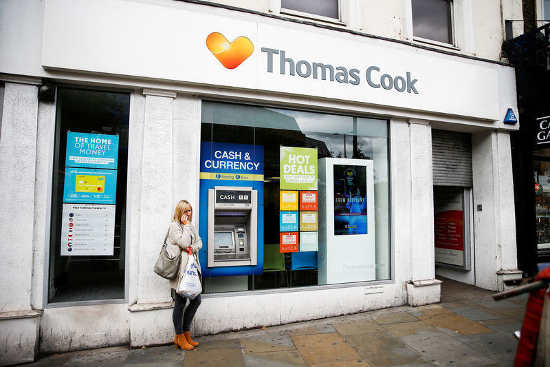 © Reuters. A woman stands on the phone outside of a closed Thomas Cook store in London