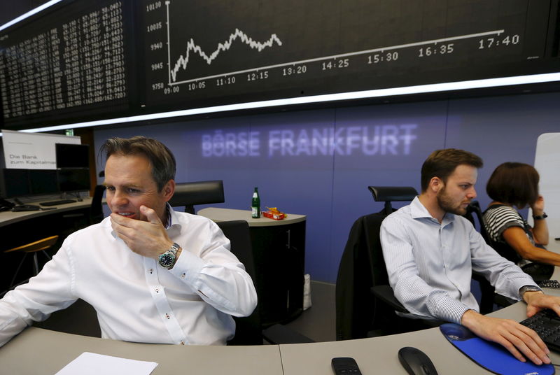 © Reuters. FILE PHOTO: A trader reacts at desk in front of DAX board at the Frankfurt stock exchange