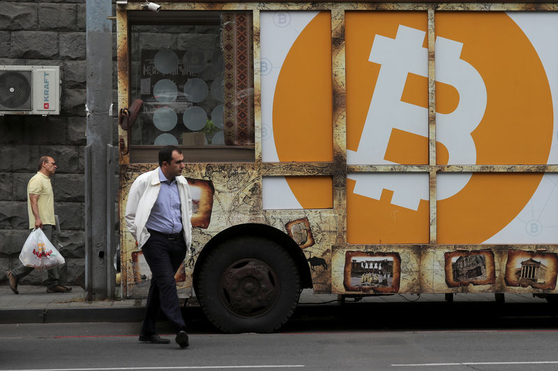 © Reuters. FILE PHOTO: A board with the logo of Bitcoin is on display in Yerevan
