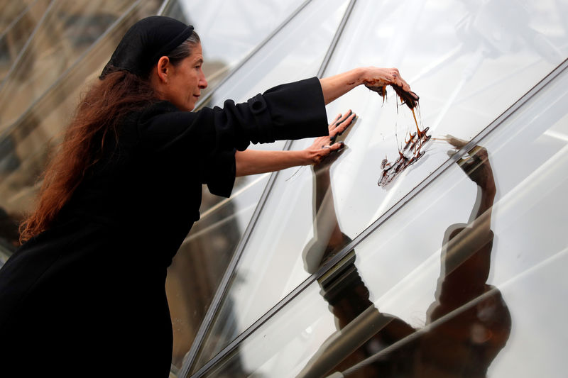 Activists daub Louvre's Pyramid with molasses in anti-Total protest