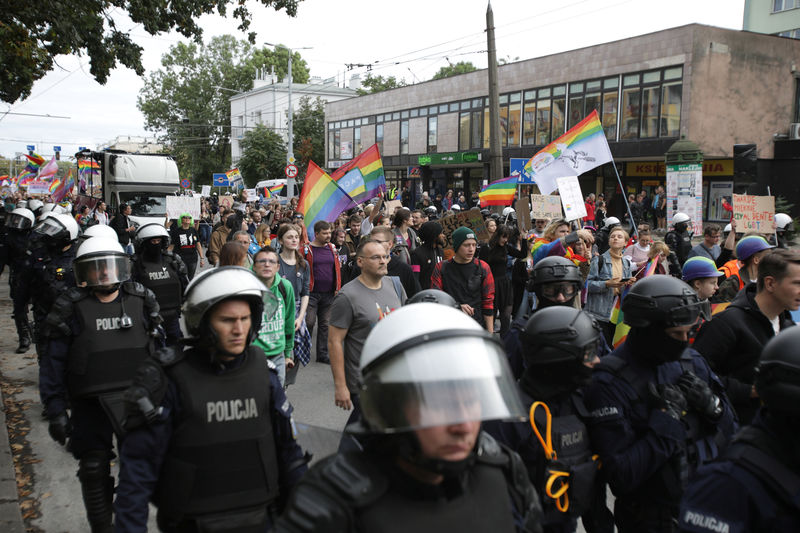 © Reuters. Police walk next to participants in Pride march in Lublin