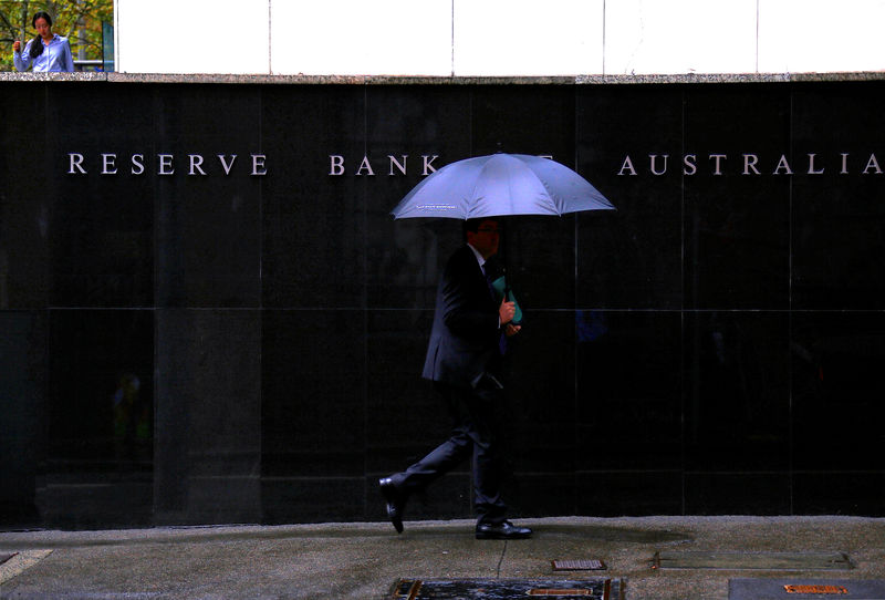 Australia central bank cuts rates to all-time low, signals may need more
