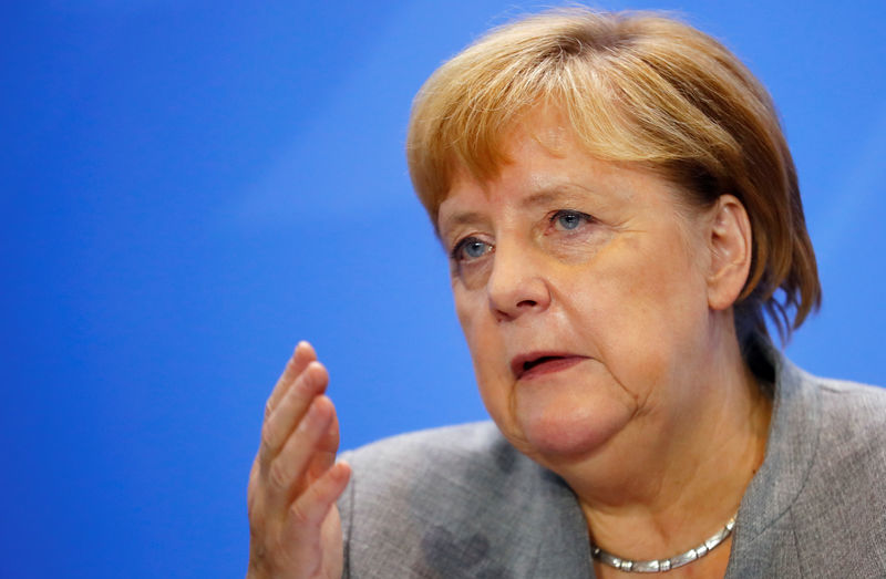 © Reuters. German Chancellor Merkel attends news conference after meeting with chairmen of international economic and financial organisations at Chancellery in Berlin