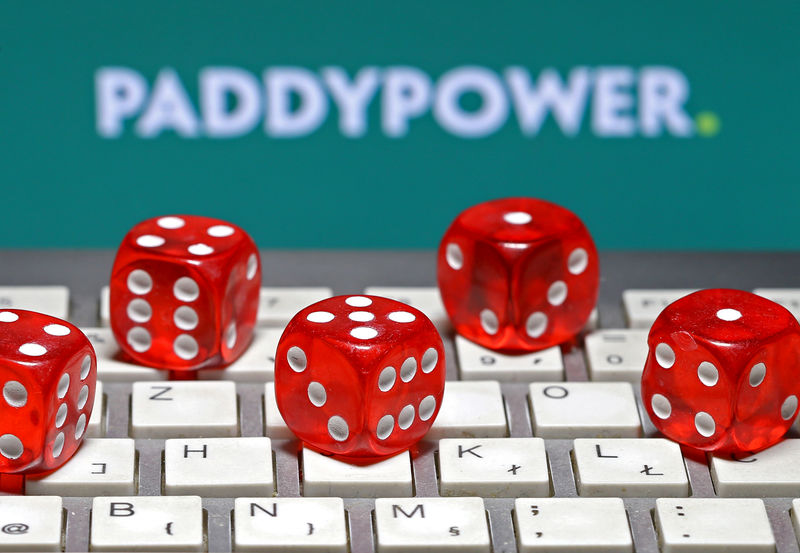 © Reuters. FILE PHOTO: Paddy Power logo is seen behind a keyboard and gambling dice in this illustration taken in Sarajevo