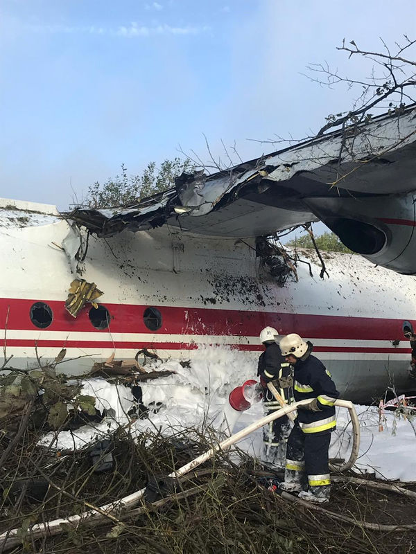 © Reuters. Members of emergency services work at the site of the Antonov-12 cargo airplane emergency landing in Lviv region