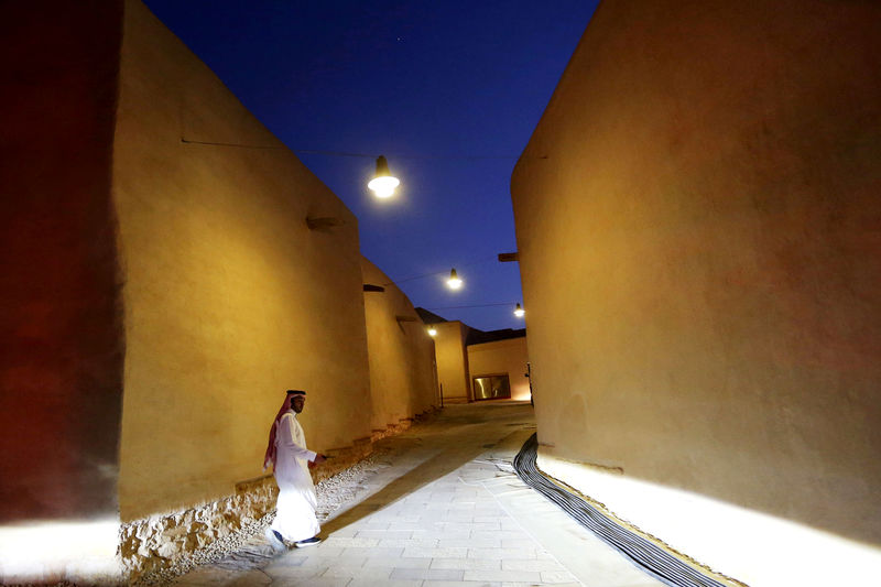 © Reuters. FILE PHOTO: A Saudi man walks past renovated buildings at the historic city of Diriyah, a UNESCO World Heritage Site, in Riyadh