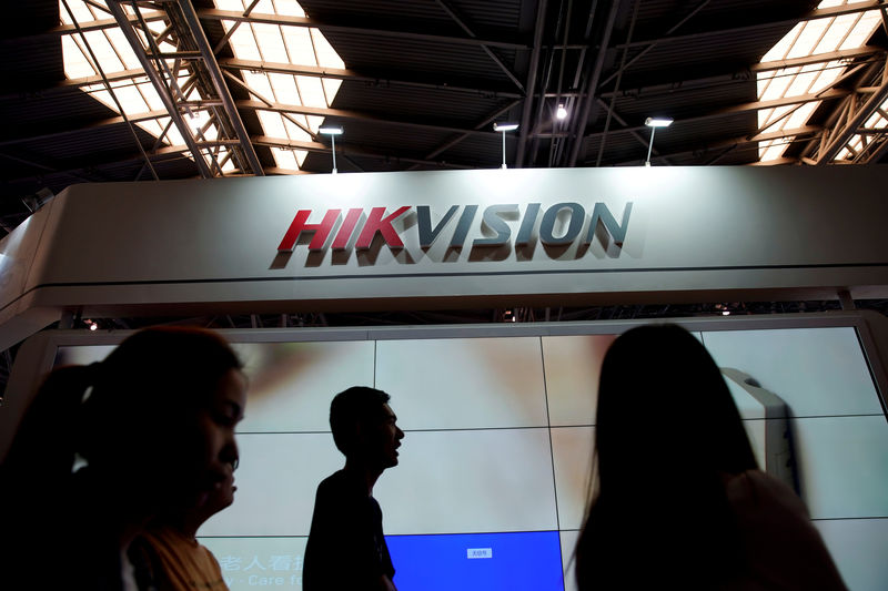 © Reuters. FILE PHOTO: People visit a Hikvision booth at a security exhibition in Shanghai