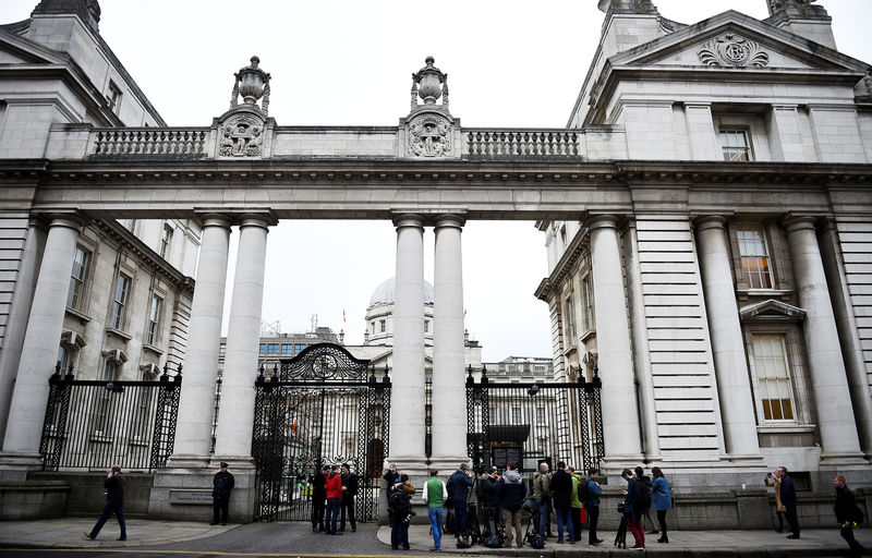 © Reuters. FILE PHOTO: Journalists wait outside Government Buildings to be escorted in for a statement by Ireland's Prime Minister Leo Varadkar (Taoiseach), in Dublin