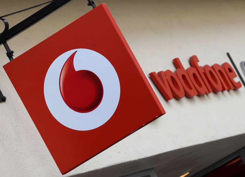 © Reuters. FILE PHOTO: Branding hangs outside a Vodafone shop in Oxford