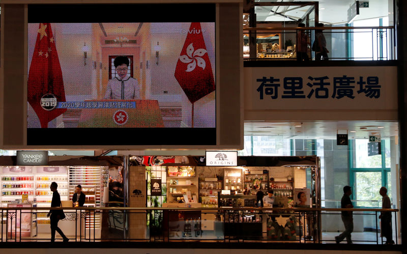 © Reuters. Hong Kong Chief Executive Carrie Lam delivers her third policy address via TV after her session at the legislative council was disrupted by heckling pro-democracy lawmakers, as seen at a shopping mall in Hong Kong