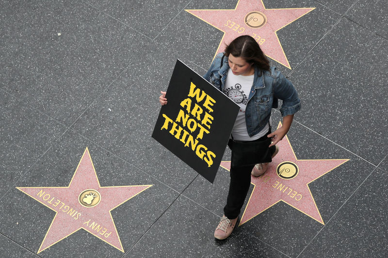 © Reuters. FILE PHOTO: A demonstrator takes part in a #MeToo protest march for survivors of sexual assault and their supporters on the Hollywood Walk of Fame in Hollywood, Los Angeles