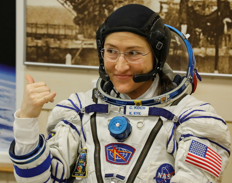 © Reuters. The International Space Station (ISS) crew member Christina Koch of the U.S. gestures after donning space suits shortly before their launch at the Baikonur Cosmodrome