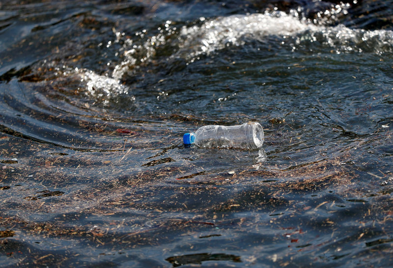 © Reuters. FILE PHOTO: A plastic bottle drifts on the waves of the sea at a fishing port in Isumi