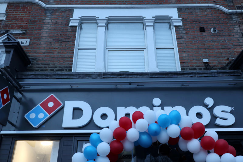 © Reuters. FILE PHOTO: Balloons are seen on the front of a newly opened Domino's Pizza franchise in London, Britain