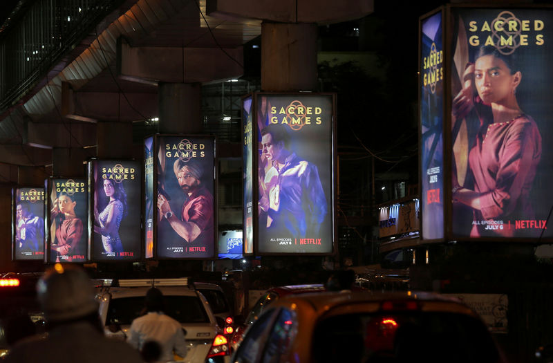 © Reuters. FILE PHOTO: Traffic moves on a road past hoardings of Netflix's new television series "Sacred Games" in Mumbai