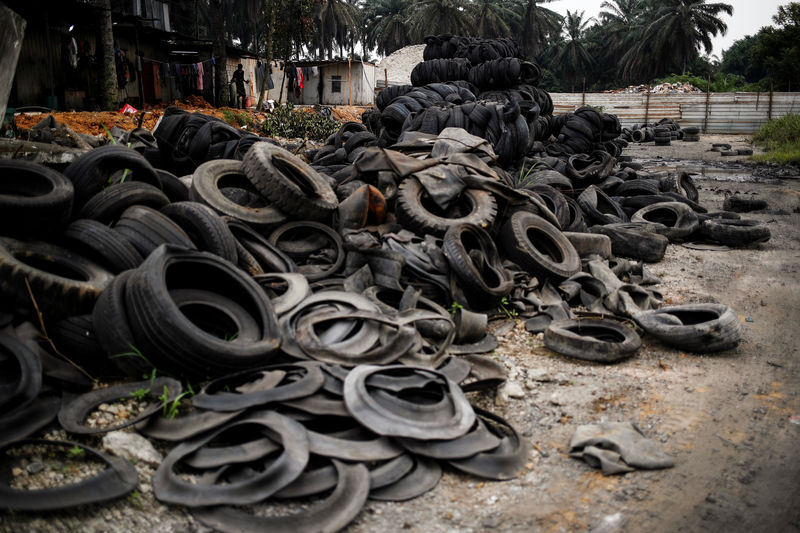 © Reuters. Bales of tyres from Australia and New Zealand are dumped at a compound next to the living quarters of the workers at a tyre pyrolysis plant in Kulai