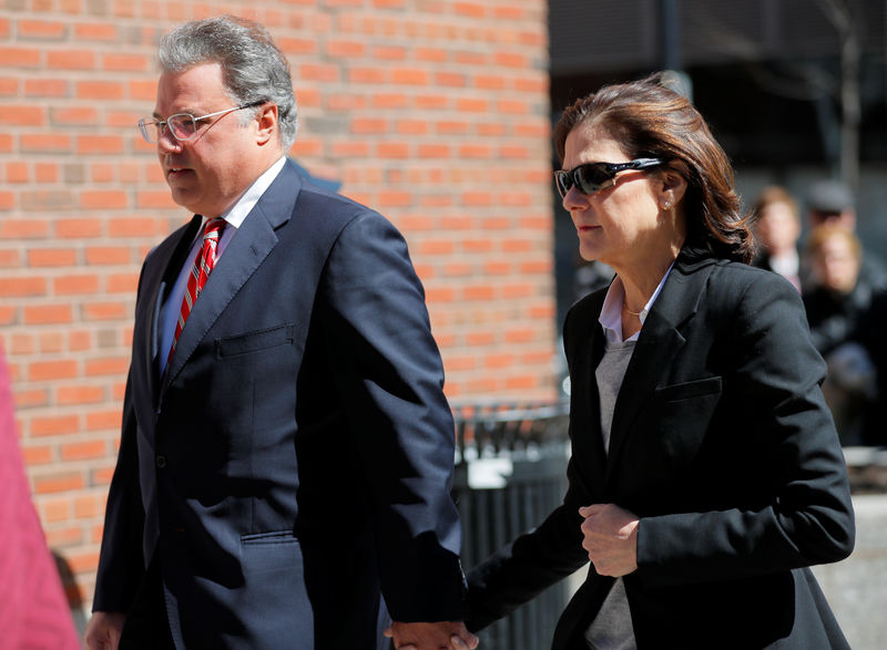 © Reuters. FILE PHOTO:  Manuel and Elizabeth Henriquez, facing charges in a nationwide college admissions cheating scheme, enter federal court in Boston