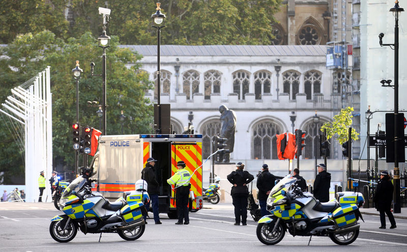 © Reuters. Police officers inspect the site where a suspicious package was found, at Whitehall, London