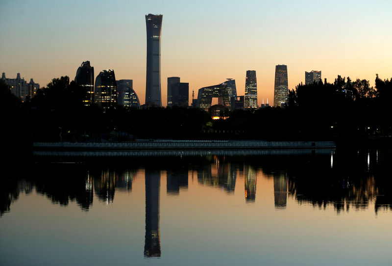 © Reuters. The cityscape of the Beijing Central Business District is reflected in a pond during sunset