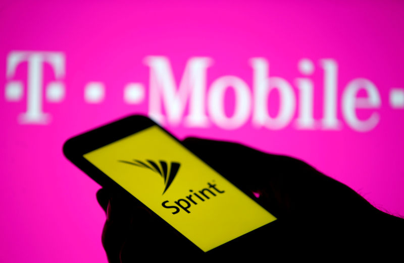 © Reuters. FILE PHOTO: A smartphone with Sprint logo are seen in front of a screen projection of T-mobile logo, in this picture illustration