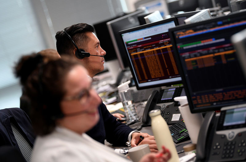 © Reuters. Traders are seen at work at Northern Trust offices in London