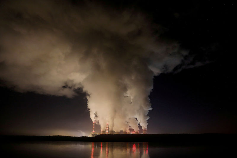 © Reuters. FILE PHOTO: Smoke and steam billows from Belchatow Power Station, Europe's largest coal-fired power plant operated by PGE Group, at night near Belchatow,