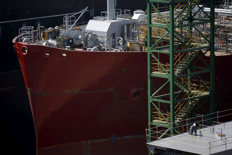 © Reuters. FILE PHOTO: A worker labours near a ship which is currently under construction at Hyundai Heavy Industries' Shipyard in Ulsan