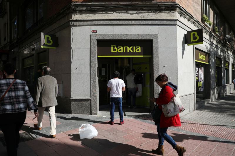 © Reuters. People wait to enter a Bankia bank branch in Madrid