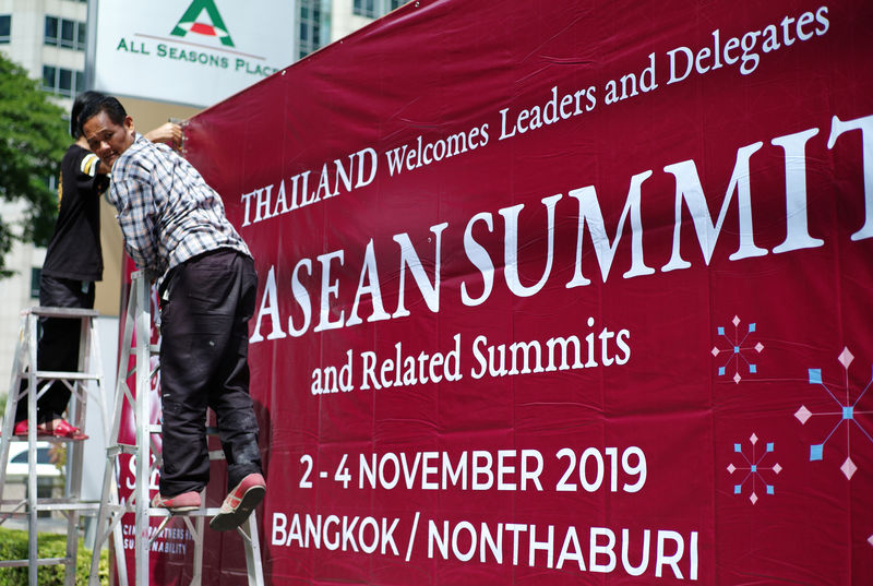© Reuters. Workers put up a sign to welcome leaders to the 35th ASEAN Summit in Bangkok