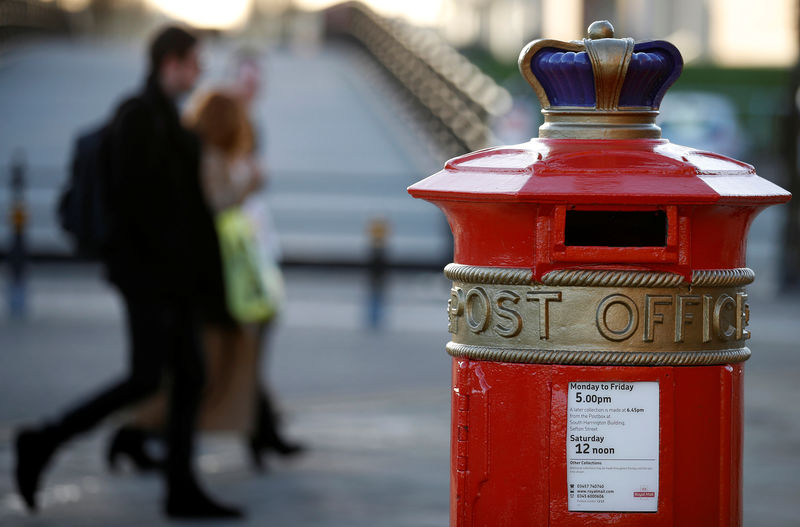 © Reuters. People walk past an ornate Royal Mail post box with Post Office written on it in Liverpool