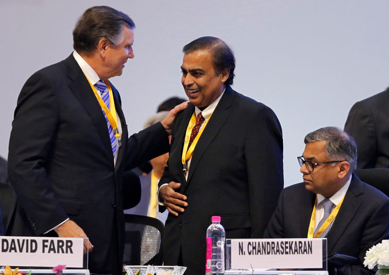 © Reuters. FILE PHOTO: David Farr, CEO of Emerson Electric speaks with Mukesh Ambani, Chairman of Reliance Industries, as Tata Sons Chairman Natarajan Chandrasekaran looks on as they attend the Vibrant Gujarat Global Summit in Gandhinagar