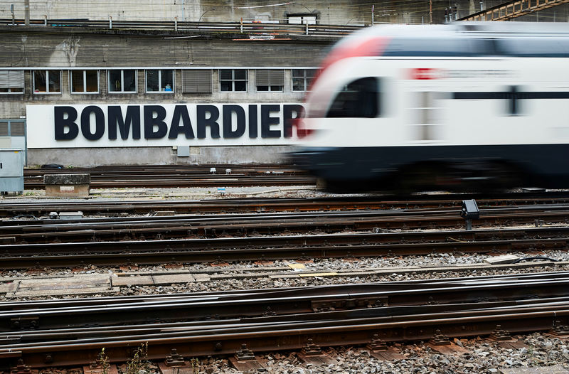 © Reuters. A Bombardier advertising board is pictured in front of a SBB CFF Swiss railway train at the station in Bern