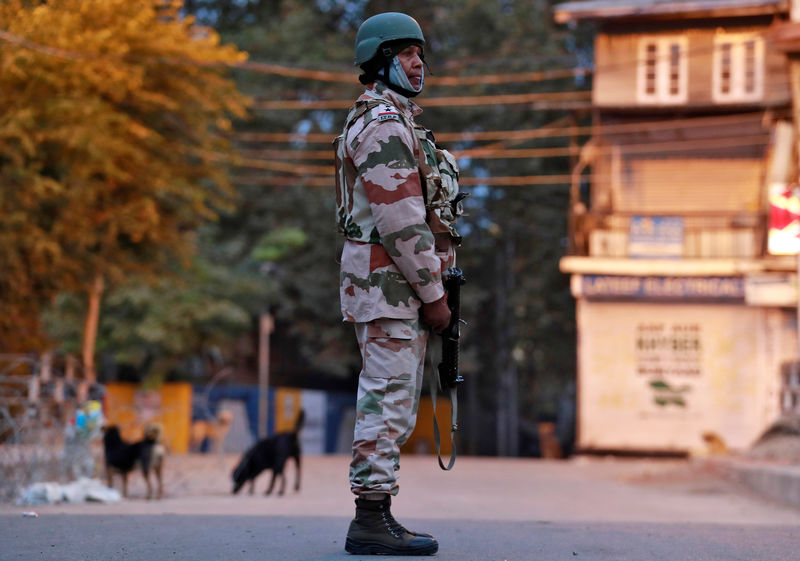 © Reuters. An Indo-Tibetan Border Police officer stands guard on a road in Srinagar