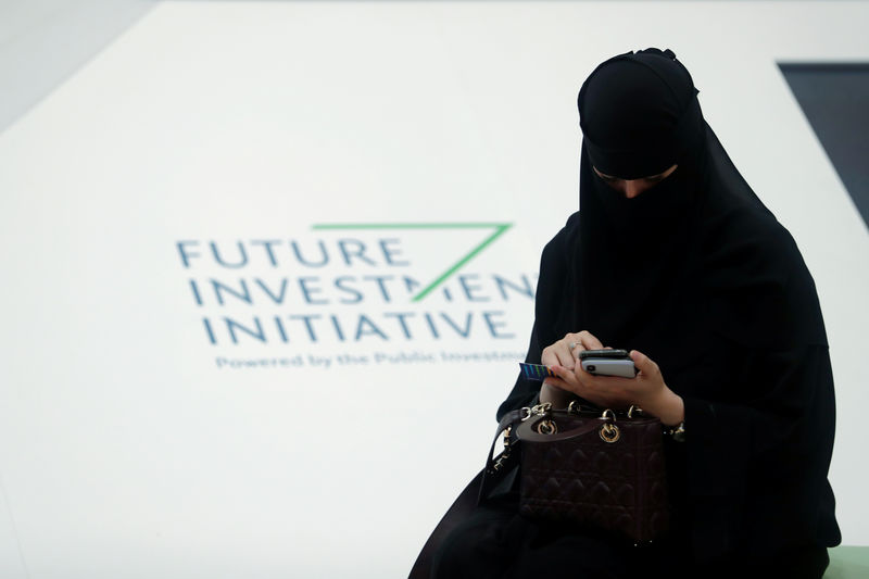 © Reuters. A Saudi woman uses her phone during the Future Investment Initiative conference in Riyadh