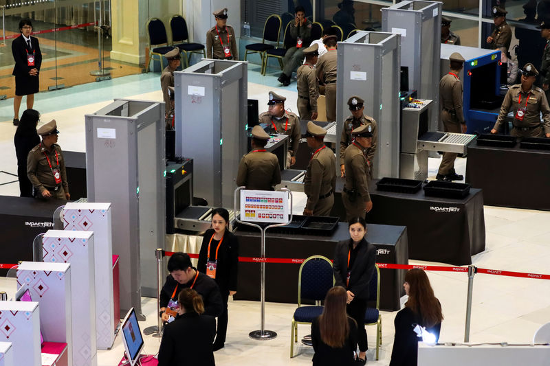 © Reuters. Police officers and security personnel are seen at a security check point at the media center at the venue for the upcoming the 35th ASEAN Summit in Bangkok