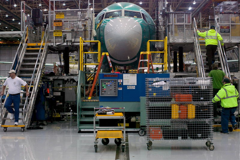 © Reuters. Boeing employees march up and down stairs entering and exiting Boeing 737 MAX during a media tour of the Boeing 737 MAX at the Boeing plant in Renton, Washington