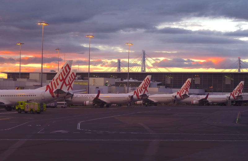 © Reuters. Aircraft from Australia's second largest airline, Virgin Australia, sit on the tarmac at the domestic terminal of Sydney Airport